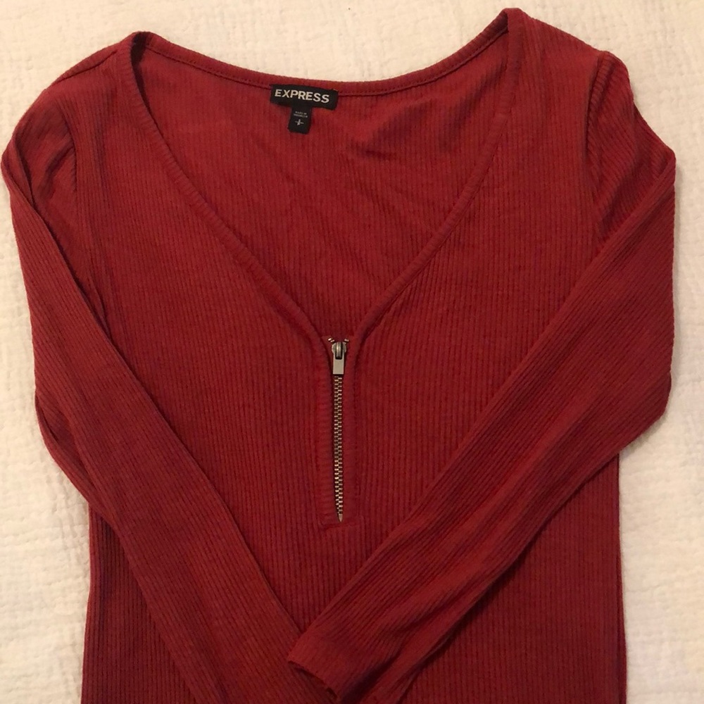 Tight, 3/4 sleeve, low zip neck.